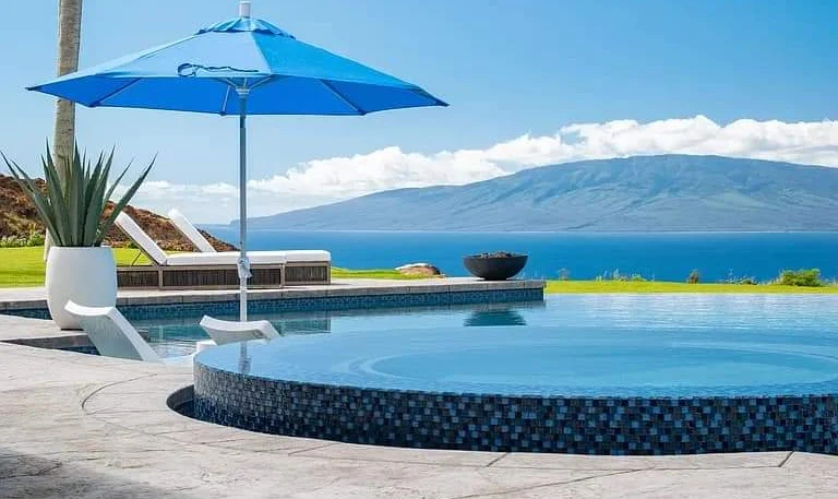 Before and after photo of a Maui pool surface restored through pool rebuffing